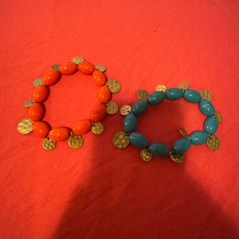 Blue and orange beaded bracelets with gold toned coin-shaped charms